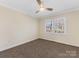 Neutral bedroom with a carpeted floor, a ceiling fan, and a bright window at 3222 Shadow Lake Ln, Matthews, NC 28104