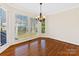 Cozy dining area with large windows, natural light, and wood floors at 3222 Shadow Lake Ln, Matthews, NC 28104