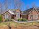 Charming brick home with manicured landscaping, large windows, and a welcoming entrance on a sunny day at 3222 Shadow Lake Ln, Matthews, NC 28104