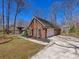 Charming brick home with a two-car garage, black shutters, and a concrete driveway at 3222 Shadow Lake Ln, Matthews, NC 28104