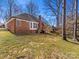 Brick home with a deck overlooking an expansive yard and mature trees at 3222 Shadow Lake Ln, Matthews, NC 28104