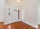 Bright foyer featuring hardwood floors, a white front door with sidelights, and neutral wall paint at 3222 Shadow Lake Ln, Matthews, NC 28104