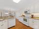 Well-lit kitchen with white cabinets, granite countertops, and modern appliances at 3222 Shadow Lake Ln, Matthews, NC 28104