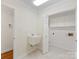 Bright laundry room featuring a utility sink, tile flooring, and built-in storage cabinets at 3222 Shadow Lake Ln, Matthews, NC 28104