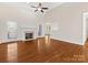 Spacious living room with hardwood floors, fireplace, windows and views to the dining room at 3222 Shadow Lake Ln, Matthews, NC 28104