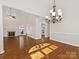 Inviting living room features hardwood floors, fireplace, and a view into the kitchen at 3222 Shadow Lake Ln, Matthews, NC 28104