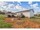 View of the back of the house and back yard, carport and lawn with play items on the ground at 340 W Memorial Hwy, Harmony, NC 28634