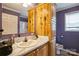 Bathroom with wood cabinet vanity, marble counter and purple walls, plus toilet with decorative floral seat at 340 W Memorial Hwy, Harmony, NC 28634