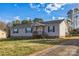 Charming single-story home with light gray siding, dark shutters, and a welcoming front porch at 340 W Memorial Hwy, Harmony, NC 28634