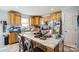 Well-lit kitchen featuring wooden cabinets, a breakfast bar with seating, and stainless steel appliances at 340 W Memorial Hwy, Harmony, NC 28634