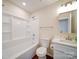 A clean bathroom with a white tub and shower combination, matching toilet and vanity with marble counter at 406 White Store Rd, Wadesboro, NC 28170