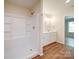 Bathroom showcasing a white shower stall, matching vanity, and wood-look flooring at 406 White Store Rd, Wadesboro, NC 28170
