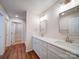 Bright bathroom featuring a double vanity with quartz countertops, modern fixtures and wood-look flooring at 406 White Store Rd, Wadesboro, NC 28170