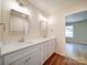 Bright bathroom featuring a double vanity with quartz countertops, modern fixtures, and wood-look flooring at 406 White Store Rd, Wadesboro, NC 28170