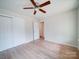 A bright bedroom featuring wood-look floors and a ceiling fan provides comfortable air circulation at 406 White Store Rd, Wadesboro, NC 28170