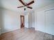 Bright bedroom with wood-look floors and a ceiling fan that provides comfortable air circulation at 406 White Store Rd, Wadesboro, NC 28170