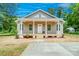 Charming home featuring a welcoming front porch with elegant white columns and a beautifully landscaped front yard at 406 White Store Rd, Wadesboro, NC 28170