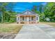 Inviting exterior view of home with front porch and sidewalk that leads to the new concrete driveway at 406 White Store Rd, Wadesboro, NC 28170