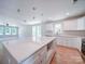 Open kitchen and living area with a spacious island, quartz countertops, and modern stainless steel appliances at 406 White Store Rd, Wadesboro, NC 28170