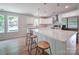 Sunlit kitchen featuring a spacious island with seating, stainless steel appliances and modern pendant lighting at 406 White Store Rd, Wadesboro, NC 28170