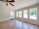 Bright living room with new hardwood floors, modern ceiling fan, and new door and window frames at 406 White Store Rd, Wadesboro, NC 28170