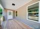 Wide covered porch with wood floors and view of the property at 406 White Store Rd, Wadesboro, NC 28170