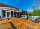 Spacious wooden back deck with sunroom and outdoor seating, perfect for entertaining or relaxing outdoors at 4127 Stacy Blvd, Charlotte, NC 28209