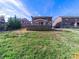 Backyard view featuring a well-maintained lawn and a wooden deck, creating an inviting outdoor space at 4127 Stacy Blvd, Charlotte, NC 28209