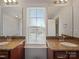 Bathroom with dual sinks and a window offering natural light and neighborhood views at 4127 Stacy Blvd, Charlotte, NC 28209