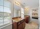 Bathroom featuring double sinks with granite countertops and lots of natural light at 4127 Stacy Blvd, Charlotte, NC 28209