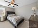 Stylish bedroom with a tufted headboard, a ceiling fan, and a classic decor at 4127 Stacy Blvd, Charlotte, NC 28209