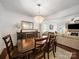 Traditional dining room featuring a wooden table, a decorative chandelier, and a view into the living room at 4127 Stacy Blvd, Charlotte, NC 28209