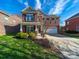 Beautiful two-story brick home with a well-manicured lawn and a welcoming front porch at 4127 Stacy Blvd, Charlotte, NC 28209