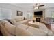 Cozy living room featuring a large sectional sofa, a fireplace with a stone surround, and a ceiling fan at 4127 Stacy Blvd, Charlotte, NC 28209