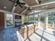 Bright sunroom with ample windows, vaulted ceilings, ceiling fans, and cozy seating around a center table at 4127 Stacy Blvd, Charlotte, NC 28209