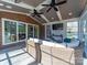 Bright sunroom featuring a ceiling fan, TV, tile floor, and cozy seating with exterior view at 4127 Stacy Blvd, Charlotte, NC 28209