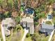 Expansive aerial view of estate featuring mature trees, pool, spa, and lush landscaping at 4536 Rustling Woods Dr, Denver, NC 28037