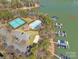 Aerial view of lake community featuring tennis courts, boat slips, and outdoor swimming pool at 4536 Rustling Woods Dr, Denver, NC 28037