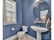 Stylish blue bathroom with a pedestal sink and window with shutters at 4536 Rustling Woods Dr, Denver, NC 28037