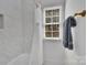 Bright bathroom featuring marble tiled walls and a window view at 4536 Rustling Woods Dr, Denver, NC 28037