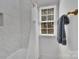 This bathroom features a tub with a shower curtain, a window with natural light, and a towel rack at 4536 Rustling Woods Dr, Denver, NC 28037