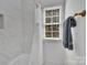 Bright bathroom featuring tiled walls, a shower and tub combination, and a window at 4536 Rustling Woods Dr, Denver, NC 28037
