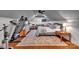 Spacious bedroom with a ceiling fan, exercise equipment, and a cozy sitting area at 4536 Rustling Woods Dr, Denver, NC 28037