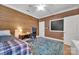 Bedroom features a wood paneled wall, a ceiling fan, and a chalkboard at 4536 Rustling Woods Dr, Denver, NC 28037