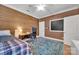 Comfortable bedroom with modern accents, wood wall, desk area and ensuite bathroom at 4536 Rustling Woods Dr, Denver, NC 28037
