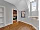 Bonus room featuring hardwood floors, a large window, and a peek into a media room at 4536 Rustling Woods Dr, Denver, NC 28037