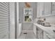 Modern butler's pantry with white cabinets, light countertops, and a wine refrigerator at 4536 Rustling Woods Dr, Denver, NC 28037