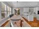 Dining room with bench seating, chandelier lighting, hardwood floors, and white trim at 4536 Rustling Woods Dr, Denver, NC 28037