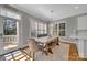 Bright dining area featuring bench seating, a stylish light fixture, and outside access at 4536 Rustling Woods Dr, Denver, NC 28037