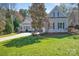 Home showcasing a well maintained lawn and basketball hoop at 4536 Rustling Woods Dr, Denver, NC 28037